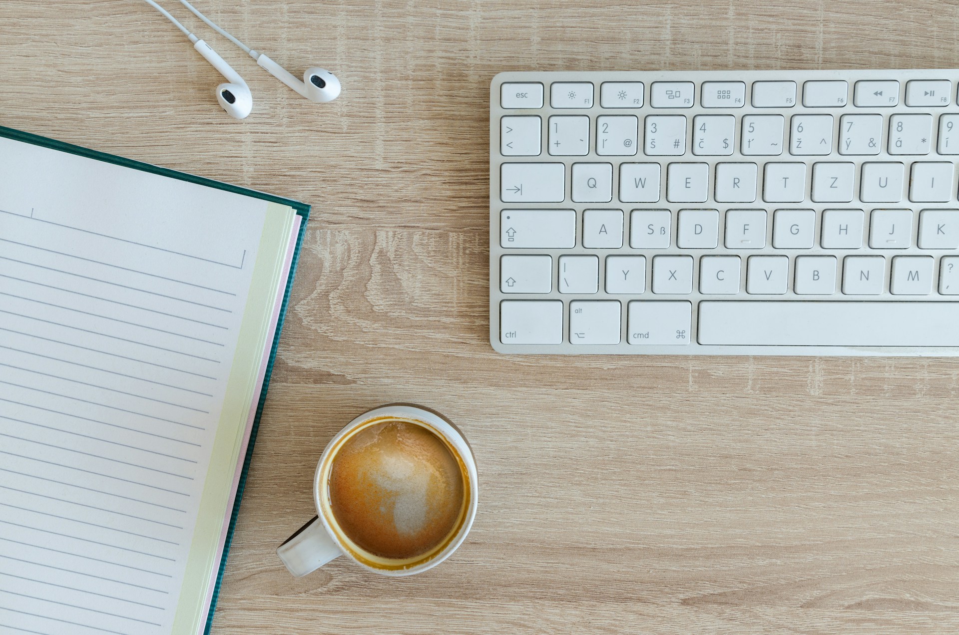 A picture of a keyboard, a cup of coffee and headphones on a table to support the accessibility news post
